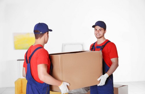 Specialist piano removals team handling a piano carefully in Swiss Cottage