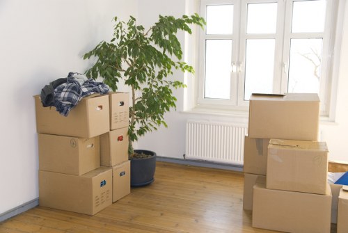 Furniture being carried carefully from an upper-floor apartment during a Swiss Cottage move