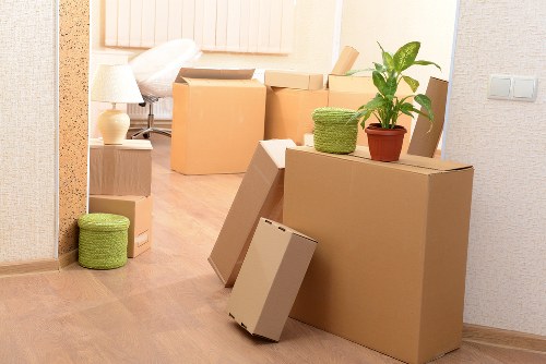 Packed boxes and furniture ready for transport in a Swiss Cottage flat move
